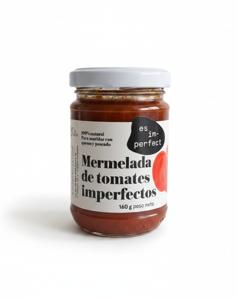 Mermelada artesanal de tomate im-perfect en frasco de 160g, con textura y color característicos del producto natural.